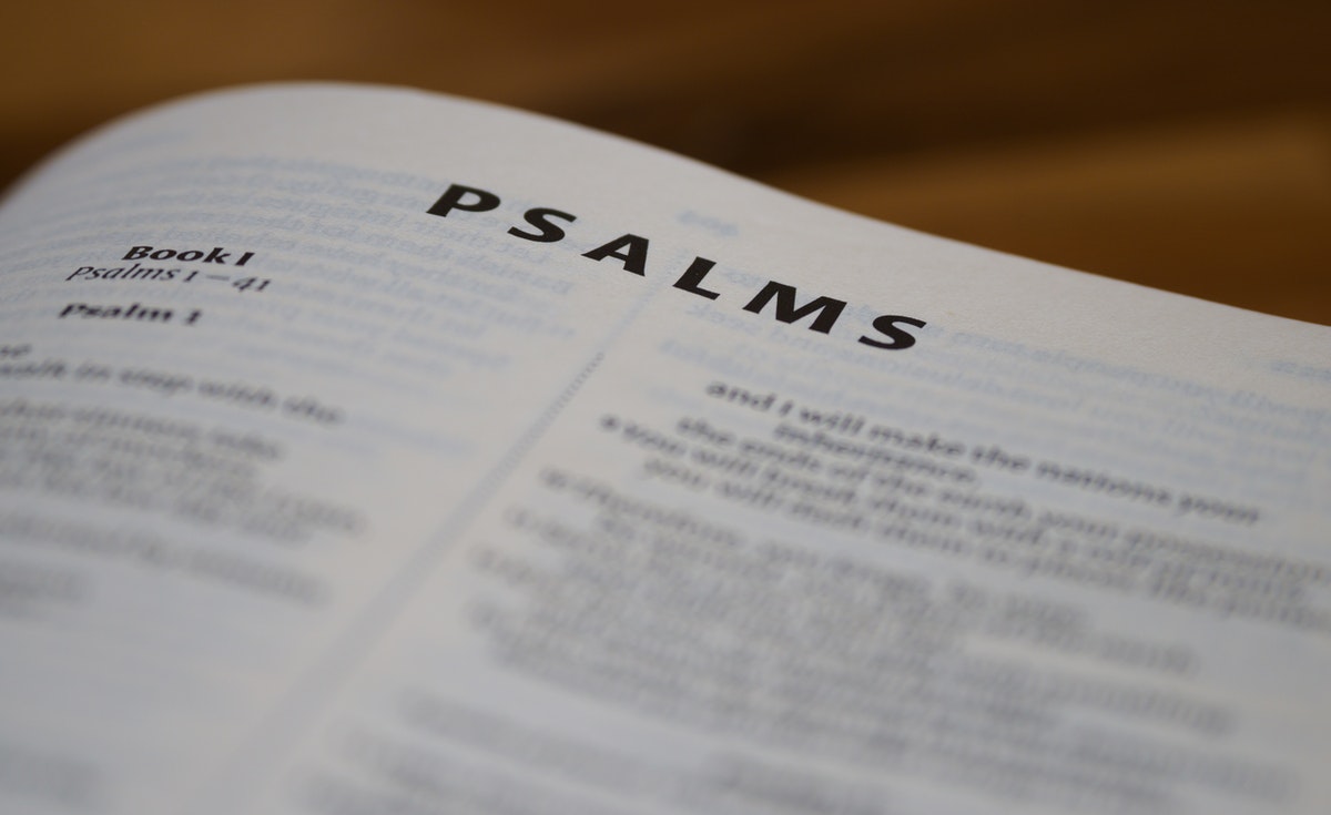 A photo of the Holy Bible opened to the book of Psalms.